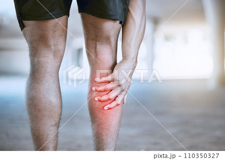 Sports man hand on a leg injury while training, exercise or workout. Red graphic to identify muscle ache or pain in the body after running accident outdoor. Athlete hurt after cardio fitness routine Sports man hand on a leg injury while training, exercise or workout. Red graphic to identify muscle ache or pain in the body after running accident outdoor. Athlete hurt after cardio fitness routine 110350327