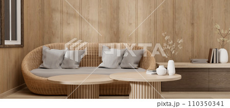 A cosy, Scandinavian living room with a wicker couch, a wooden coffee table, and a wooden wall. 110350341