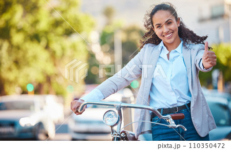 A bike, thumbs up and happy business woman taking a ride around the city for wellness or fitness. Bicycle, portrait and female rider training or cycling or on a workout for biking sports in town. 110350472