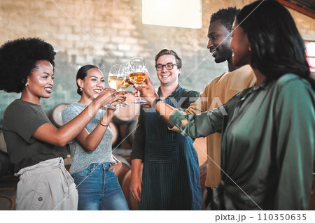 Friends wine tasting, giving cheers and toast celebrate with champagne glasses in cellar, distillery and brewery. Group of happy, diversity and smile people for social event, hangout and winery tour 110350635