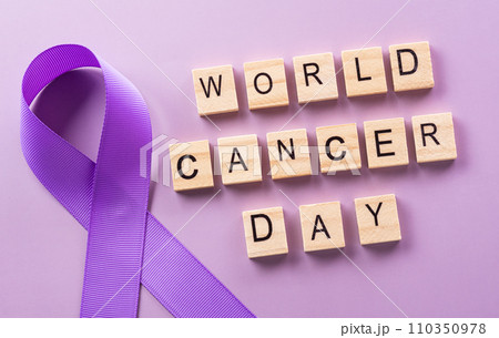 Purple ribbon and the text on pastel paper background for supporting World Cancer Day campaign on February 4. 110350978