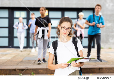 Girl in with backpack and notebooks going to college Girl in with backpack and notebooks going to college 110350997
