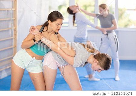 Females practicing self defence moves 110351071