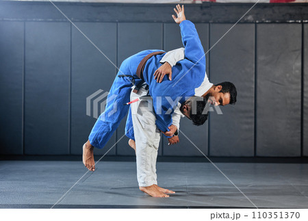 . Mma, fitness and training with a teacher and student doing exercise or workout to learn and practice in a gym or sports studio. Health, wellness and self defense or karate with a teaching coach. 110351370