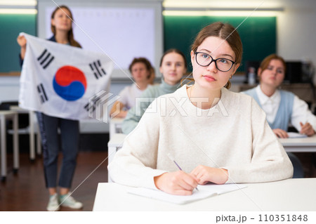 Young girl student diligently studies at school 110351848