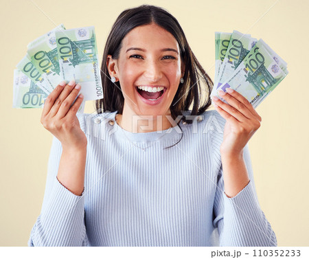 . Money, investment growth and finance success of a happy, excited and smiling woman holding cash. Portrait of a young happy female enjoying her growing financial wealth and savings with a big smile. 110352233