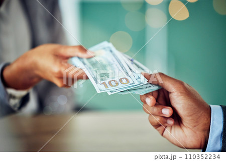Hands, dollars and businessmen exchanging cash at a bank, making a purchase or deal. Closeup of money, investment and business doing its accounting. African entrepreneur paying for a service or loan. Hands, dollars and businessmen exchanging cash at a bank, making a purchase or deal. Closeup of money, investment and business doing its accounting. African entrepreneur paying for a service or loan. 110352234