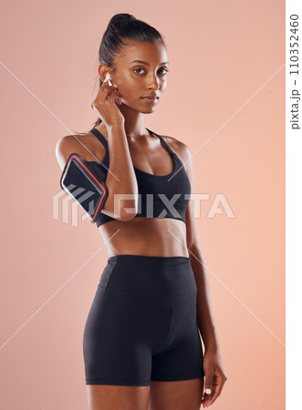 A listening to music, fit and healthy slim woman living a active, wellness and body or weight watching lifestyle. Fitness, training and sports lover ready for workout routine with athletic sportswear 110352460