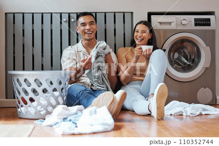 Happy, relaxed and responsible couple doing laundry, household chores or cleaning together on the weekend at home. Young millennial boyfriend and girlfriend enjoying their new modern washing machine 110352744