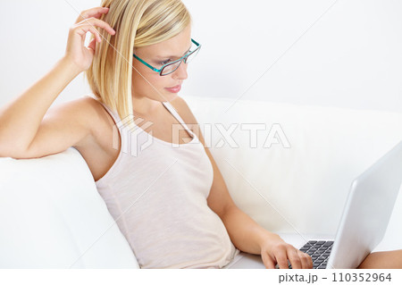 Reading, laptop and woman on sofa for remote work, research and internet project on white background. Freelance, business worker and person on computer for working from home, planning and schedule 110352964
