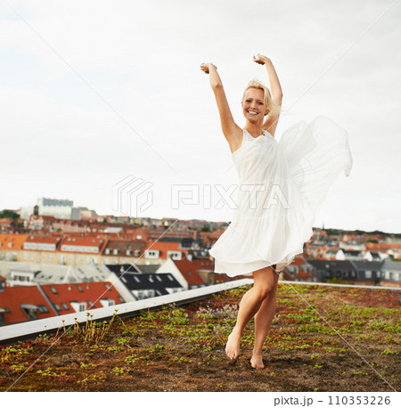 Woman, happiness and dancing on rooftop, carefree and outdoor with freedom, smiling and city. Wind, dancer and urban area for break, summer and smile on trip, barefoot and amsterdam spring time Woman, happiness and dancing on rooftop, carefree and outdoor with freedom, smiling and city. Wind, dancer and urban area for break, summer and smile on trip, barefoot and amsterdam spring time 110353226