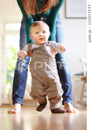 Mother, baby and face with help for walking in home for motor skills, development or milestone with assistance. Son, toddler and excited for mobility, movement or freedom in living room with support Mother, baby and face with help for walking in home for motor skills, development or milestone with assistance. Son, toddler and excited for mobility, movement or freedom in living room with support 110353547