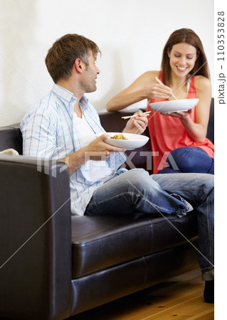 Couple, dinner and living room couch with conversation an discussion with food and chopsticks. Lounge, happy and marriage with lunch and eating with a smile and communication on a sofa with love 110353828