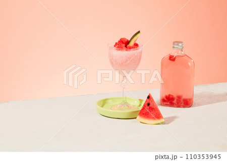 A watermelon smoothie, fresh watermelon slices and a transparent bottle of detox water on a pastel background. Empty space for text design. Advertising. A watermelon smoothie, fresh watermelon slices and a transparent bottle of detox water on a pastel background. Empty space for text design. Advertising. 110353945