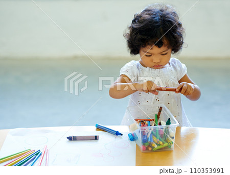 Young girl, crayons and drawing in classroom for creative development, education growth in kindergarten. Child, daycare or table pencils artwork for learning play school or paper, craft idea or color 110353991