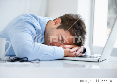 Businessman, laptop and sleeping on office desk in burnout, stress or fatigue from pressure or overworked. Tired man or employee asleep on table with computer in mental health or anxiety at workplace 110354181