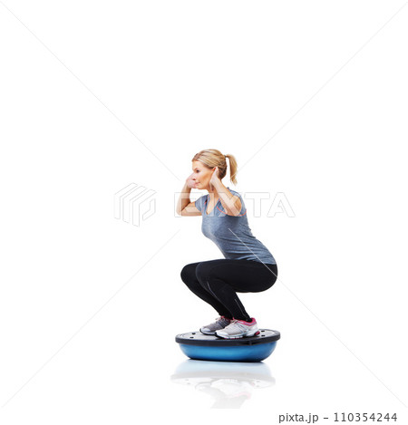 Woman, squat and exercise on bosu ball for workout, training or practice on a white studio background. Active female person on half round object for pilates, fitness or strong glutes on mockup space 110354244
