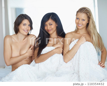 Friends, portrait and women in the nude in the bedroom for sleeping, relax and bonding together. Happy, diversity and people or young girls with blanket covering naked body in a house at a sleepover Friends, portrait and women in the nude in the bedroom for sleeping, relax and bonding together. Happy, diversity and people or young girls with blanket covering naked body in a house at a sleepover 110354432