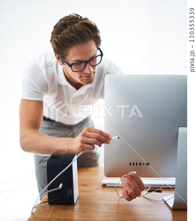 Computer, man and technician on cable connection, hardware and repair digital desktop. Pc, engineer and plug wire on port of electronics, nerd fixing system and information technology professional 110355339