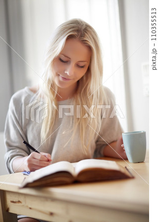 Coffee, relax and woman writing in a book at home for idea, planning or creative, research or diary. Notebook, education and female student in a house with tea while brainstorming homework assignment 110355513