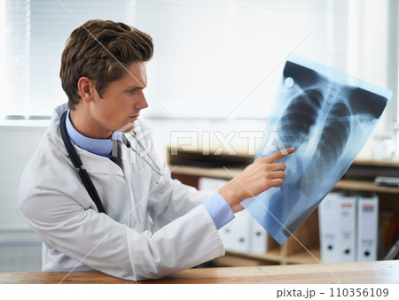 Man doctor in office, analysis of xray and health, medical diagnosis and review of lung scan at cardiology clinic. Radiology, assessment of results and human anatomy with surgeon, MRI and skeleton Man doctor in office, analysis of xray and health, medical diagnosis and review of lung scan at cardiology clinic. Radiology, assessment of results and human anatomy with surgeon, MRI and skeleton 110356109