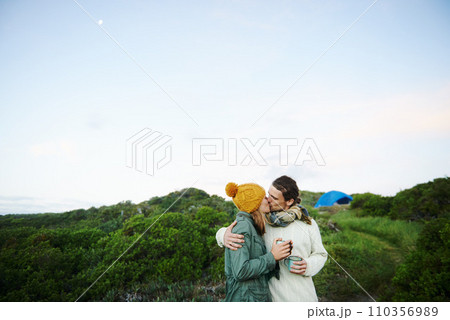 Sharing a loving kiss outdoors. an affectionate young couple kissing outdoors. 110356989