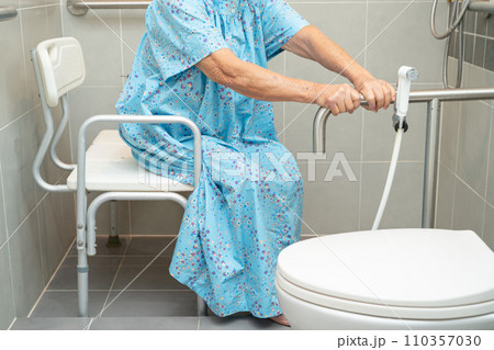 Asian elderly woman patient use toilet bathroom handle security in nursing hospital, healthy strong medical concept. 110357030