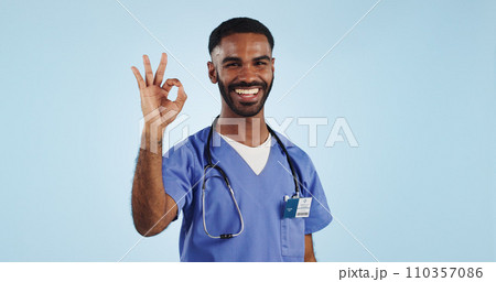 Happy man, okay or portrait of doctor with smile, pride or confidence isolated on blue background. Wellness, perfect or healthcare worker with approval sign, success or yes hand gesture in studio 110357086