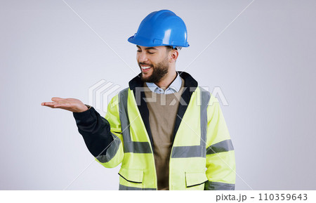 Happy man, architect and palm for advertising or marketing against a gray studio background. Male person, contractor or engineer smile with hard hat and hand out for deal or service in construction 110359643