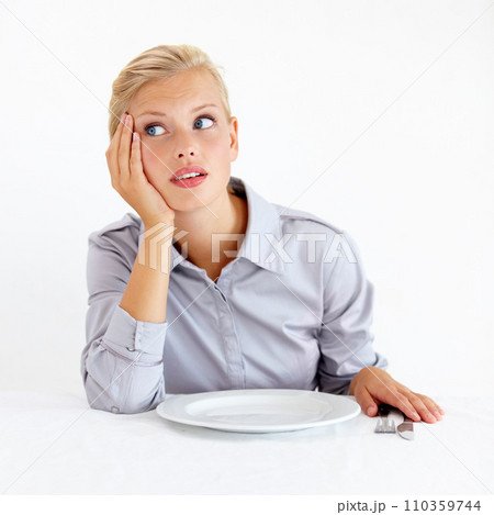 Bored, upset and woman with a plate in a studio with starving, frustrated and grumpy face. Angry, hungry and young female person from Australia with dish and cutlery isolated by white background. 110359744