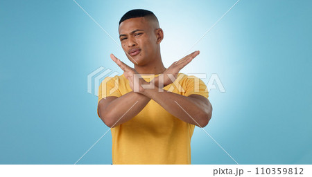 Man, cross and hands for no, portrait or studio with frustrated face for choice by blue background. Person, sign and icon for stop, warning and attention with block emoji, decline or annoyed for fail Man, cross and hands for no, portrait or studio with frustrated face for choice by blue background. Person, sign and icon for stop, warning and attention with block emoji, decline or annoyed for fail 110359812