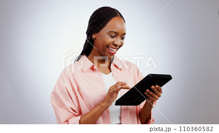 Woman, student and tablet for online research, typing information or e learning registration in studio. Happy african person on digital technology for college or reading website on a white background Woman, student and tablet for online research, typing information or e learning registration in studio. Happy african person on digital technology for college or reading website on a white background 110360582