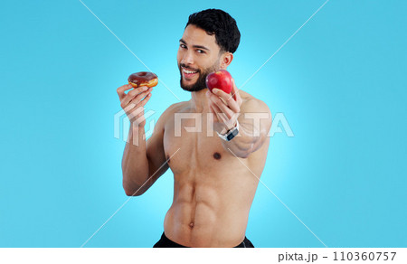 Happy man, portrait and apple with donut for diet, health or nutrition against a blue studio background. Male person or athlete showing natural organic red fruit with chocolate desert on mockup space Happy man, portrait and apple with donut for diet, health or nutrition against a blue studio background. Male person or athlete showing natural organic red fruit with chocolate desert on mockup space 110360757