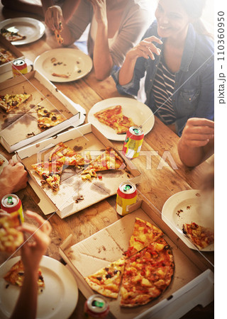 All you can eat. a group of friends enjoying pizza together. All you can eat. a group of friends enjoying pizza together. 110360950