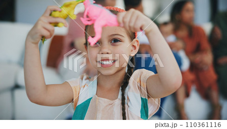 Girl kid, dinosaur toys and smile for playing, development and relax with game in living room at family house. Child, plastic reptile and happy in lounge and youth for fantasy, learning and home 110361116