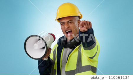 Construction worker, builder or angry man with megaphone in studio for renovation or development. Speaking, pointing or male engineer shouting in building project or communication on blue background Construction worker, builder or angry man with megaphone in studio for renovation or development. Speaking, pointing or male engineer shouting in building project or communication on blue background 110361134