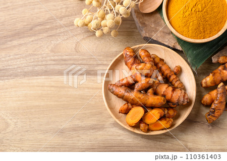 Fresh turmeric and powder, Spice in Asian cuisine, Table top view Fresh turmeric and powder, Spice in Asian cuisine, Table top view 110361403