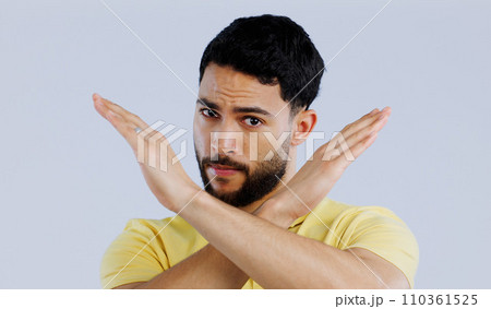 Portrait, man and cross sign for stop, no and protest for rejection, ban and wrong emoji in studio on white background. Indian model warning of caution, cancel decision and objection to vote 110361525