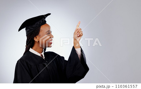 Graduate, woman pointing up and space for education, learning or college presentation and study opportunity in studio. African student information, registration steps or offer on a white background Graduate, woman pointing up and space for education, learning or college presentation and study opportunity in studio. African student information, registration steps or offer on a white background 110361557