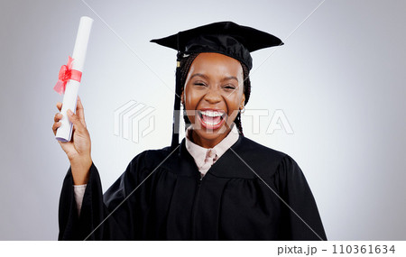 Graduation, woman and student certificate in education, college or university success on a white background. Excited portrait of african graduate with award, diploma or learning achievement in studio 110361634
