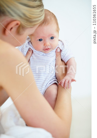 Care, family and mother with baby, love and cheerful with trust, playful and happiness with newborn. Mama holding child, kid and mom with nursery in a home, relax and bonding together with wellness 110361655