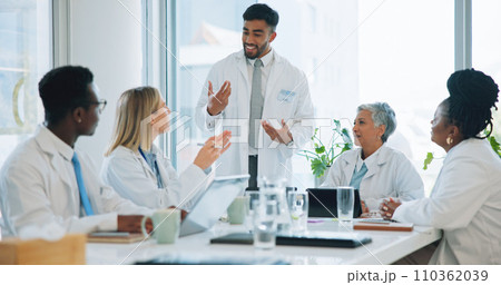 Man, doctor and team in meeting for healthcare, planning or strategy together at hospital or office. Group of medical employees in teamwork, discussion or collaboration for presentation at clinic 110362039