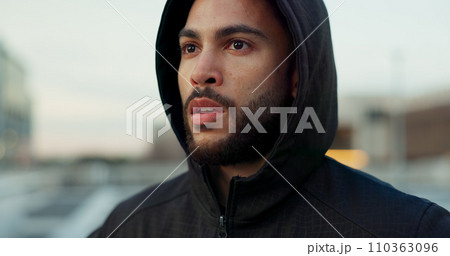Fitness, breathing and thinking, man in city on rest from morning wellness workout in hoodie. Relax, face and tired athlete on calm urban exercise with fatigue, reflection and outdoor air on street. 110363096