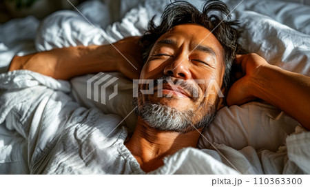 Portrait of an adult man smiling in his sleep, sunlight on his face, World Sleep Day concept Portrait of an adult man smiling in his sleep, sunlight on his face, World Sleep Day concept 110363300
