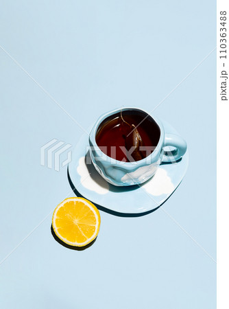 Lemon tea cup with teabag and lemon fruit. 110363488