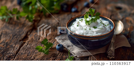 Banner with Georgian yogurt - matsoni in a ceramic bowl and with copy space for a concept, an idea for breakfast in an old traditional cafe, gastronomic tourism and travel to popular places 110363917