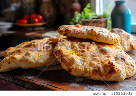 Fresh bread from the bakery next door, favorite bakeries near the house, traditional Georgian Puri bread on an old wooden table, the freshest fragrant bread Fresh bread from the bakery next door, favorite bakeries near the house, traditional Georgian Puri bread on an old wooden table, the freshest fragrant bread 110363932