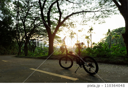 A folding bike on sunset road 110364048
