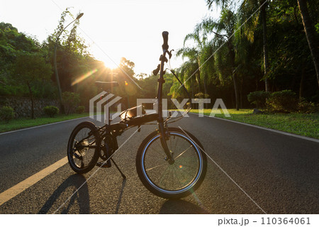 A folding bike on sunset road A folding bike on sunset road 110364061