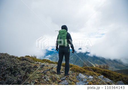 Hiking woman on high altitude mountain top 110364143
